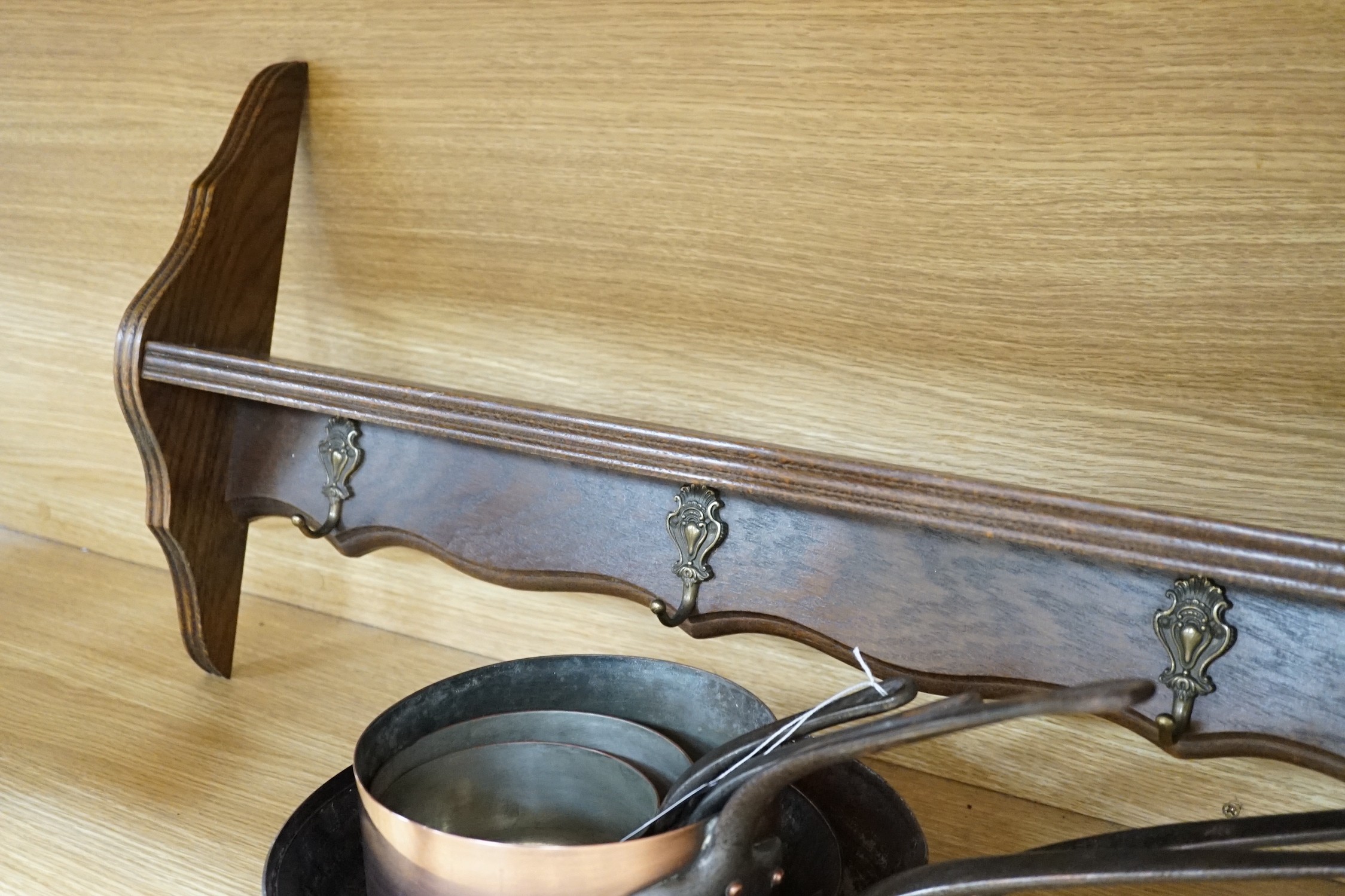 Two copper frying pans by Yves Gautier in Villedieu and three saucepans with an oak 5 hook pan rack